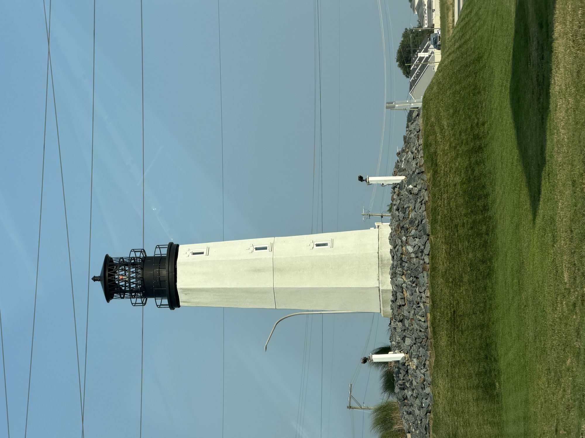 The Fenwick Island Lighthouse tower against a clear sky